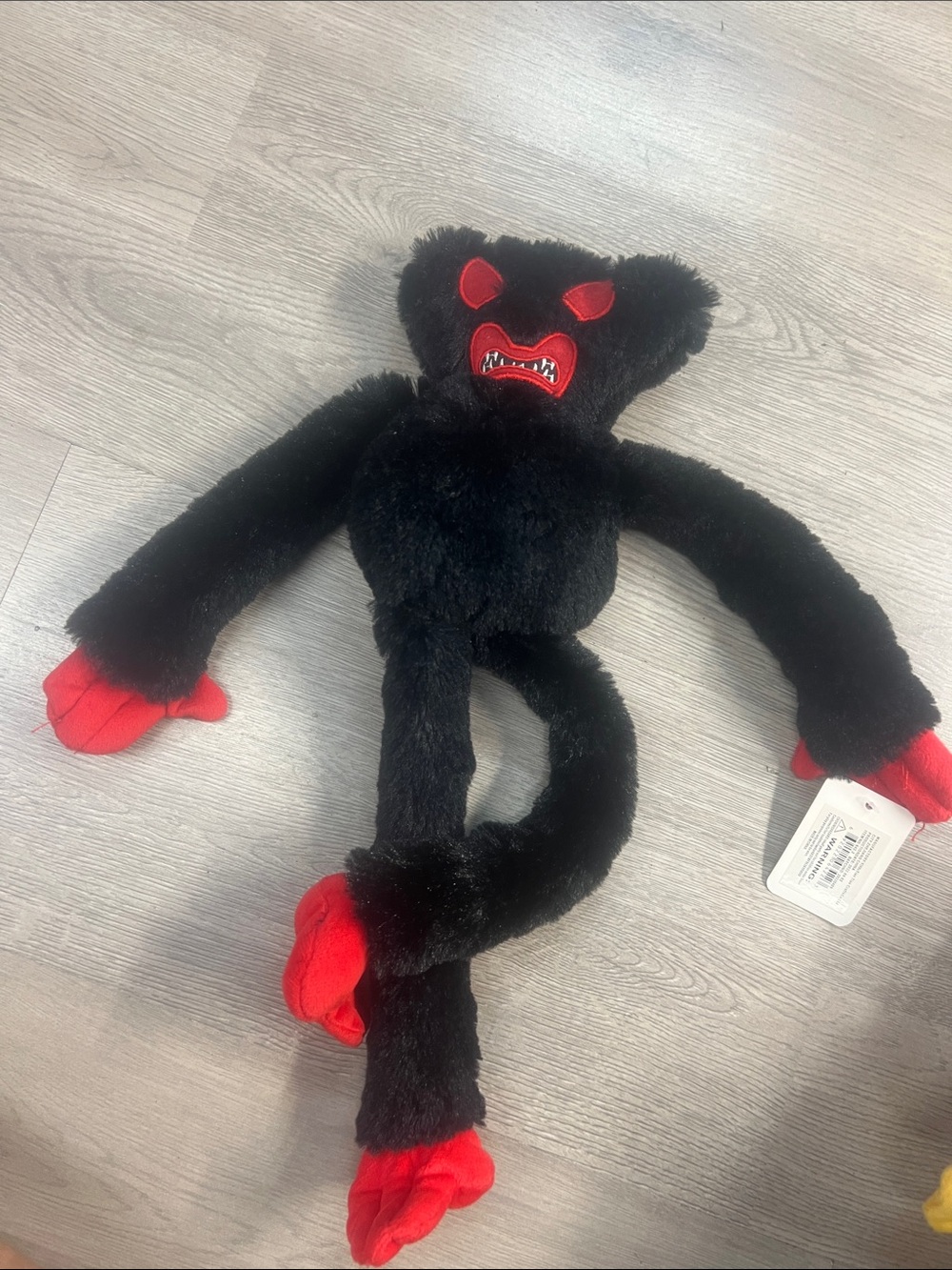Black Plush Monster Toy with Red Accents